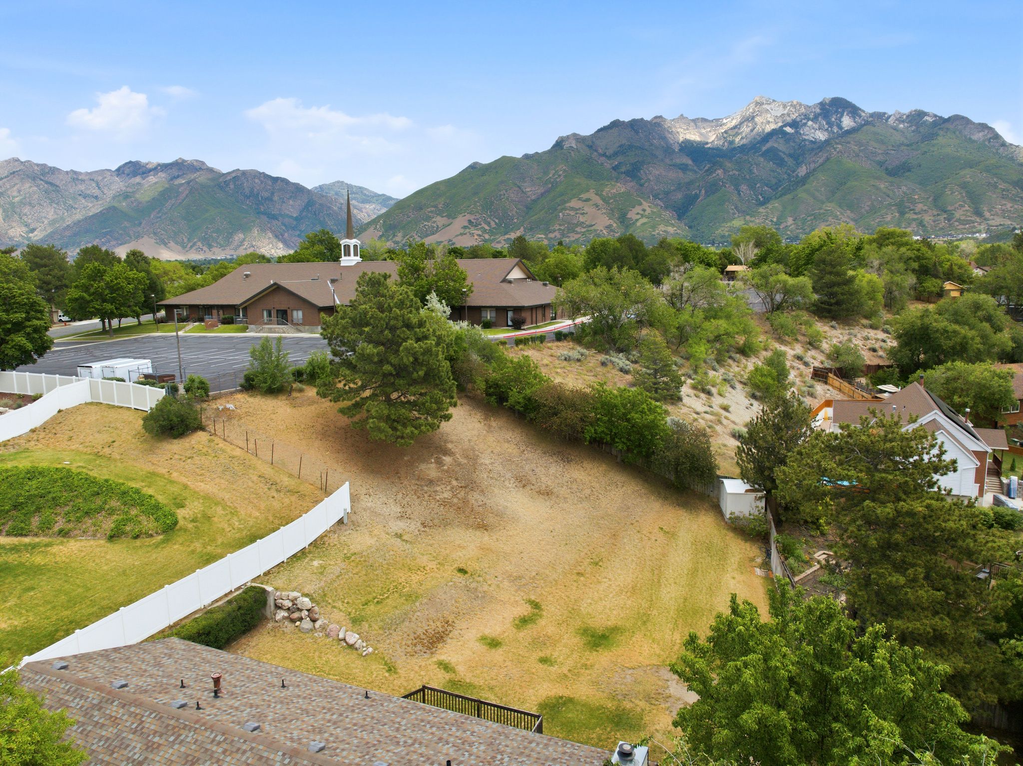Expansive mountain backdrop featuring multiple peaks and verdant foothills