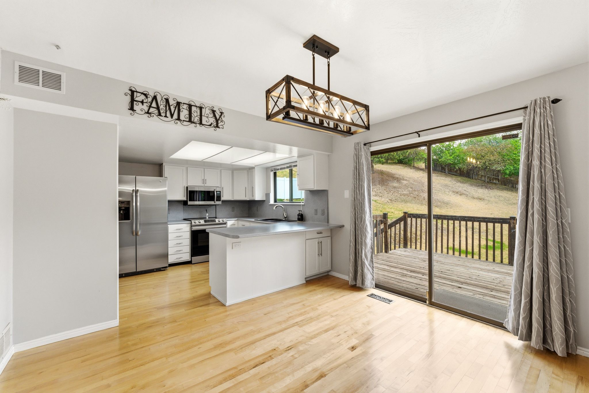 Open-concept living space with wood-finish flooring