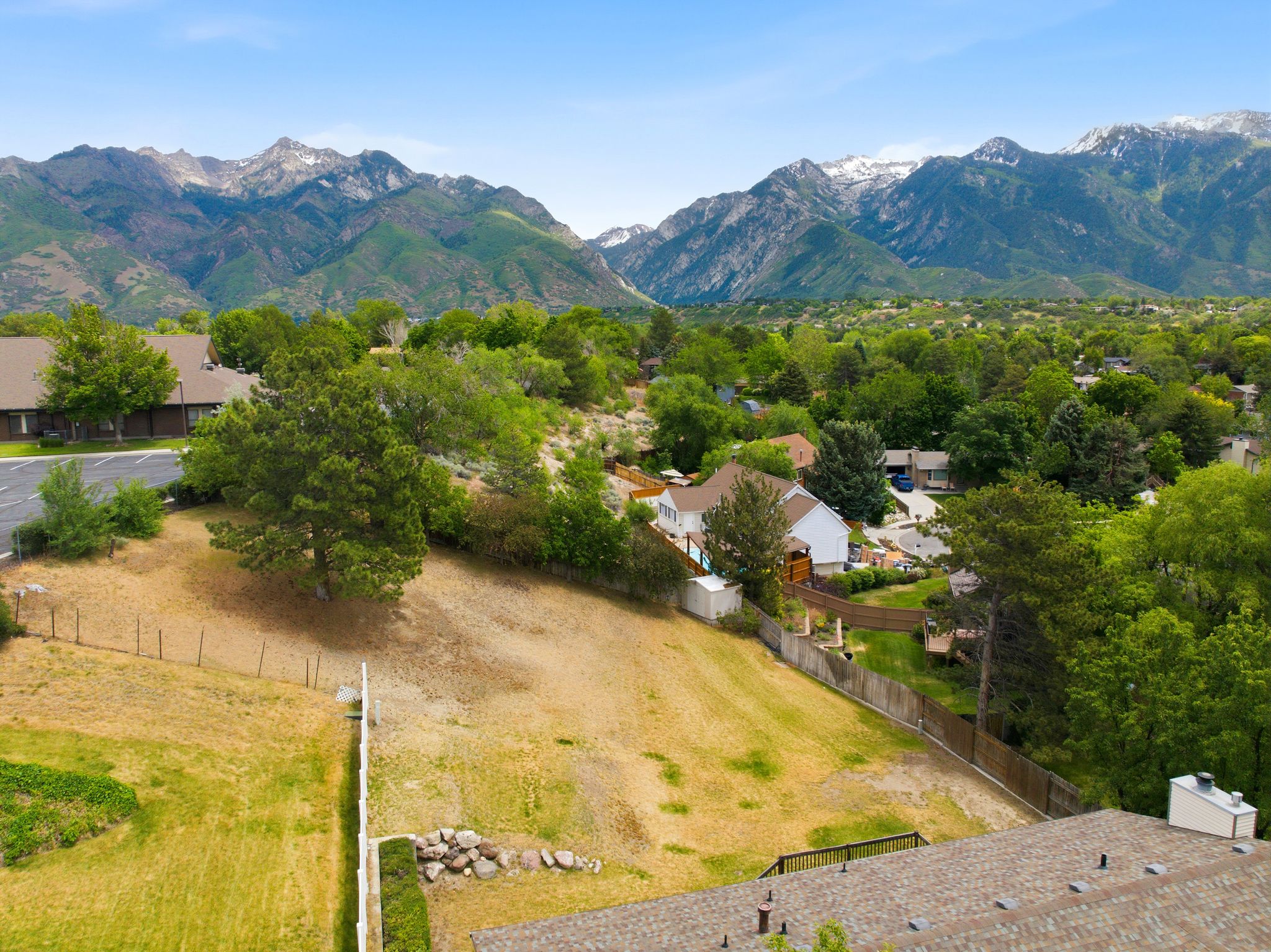 Expansive lot with mature trees and mountain scenery