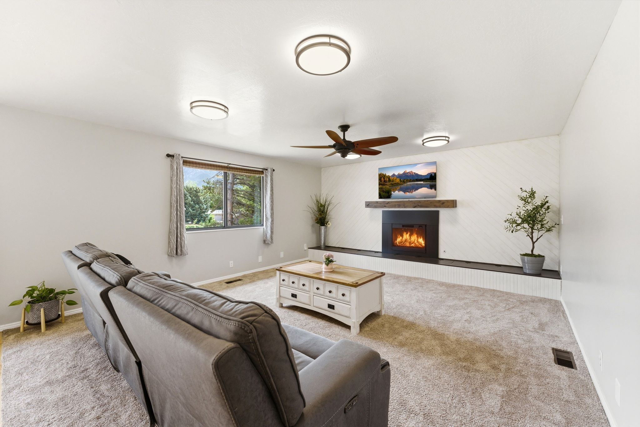 Wall-mounted fireplace with a rustic wood mantel and decorative paneling