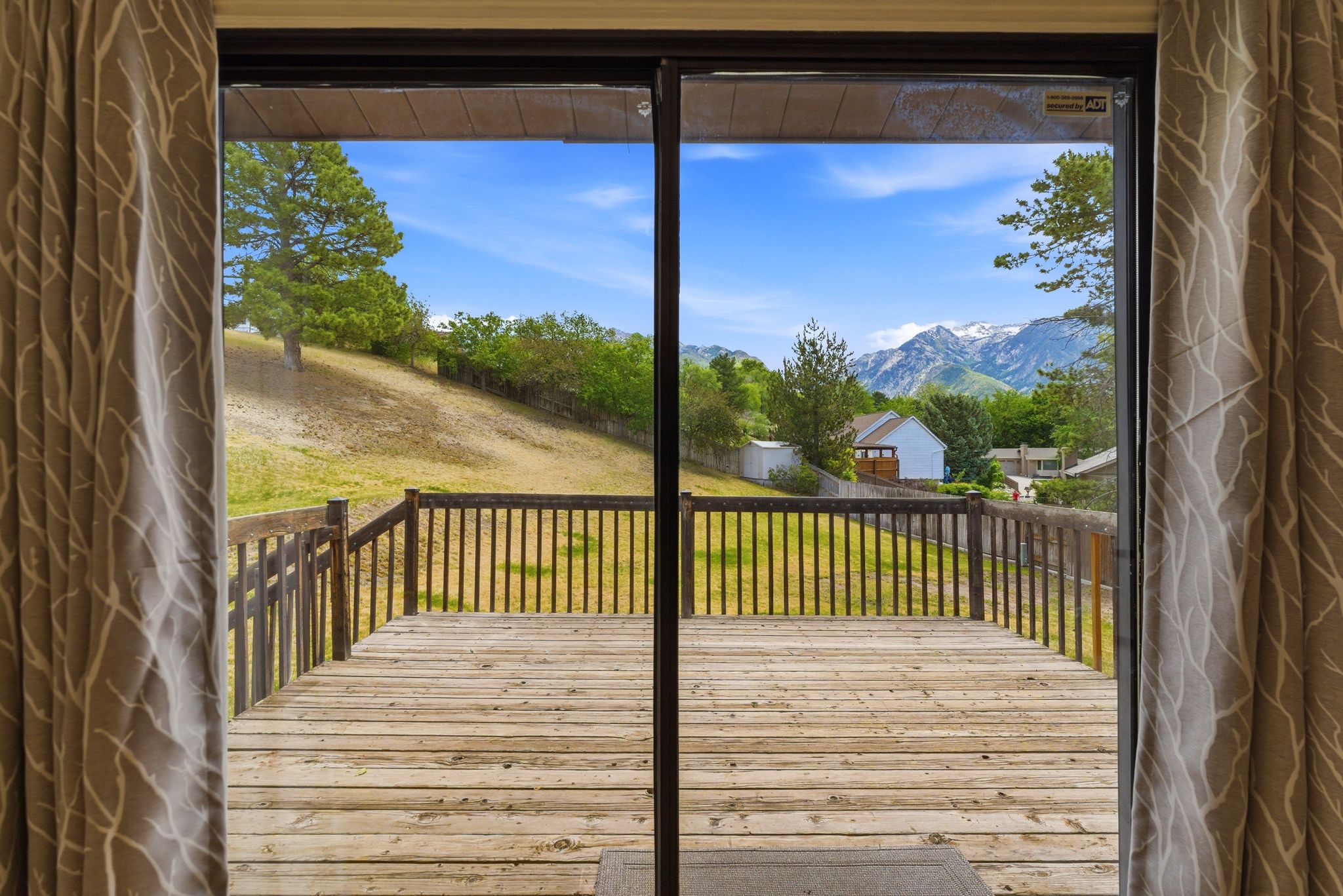 Sliding glass door opening to an exterior wood deck