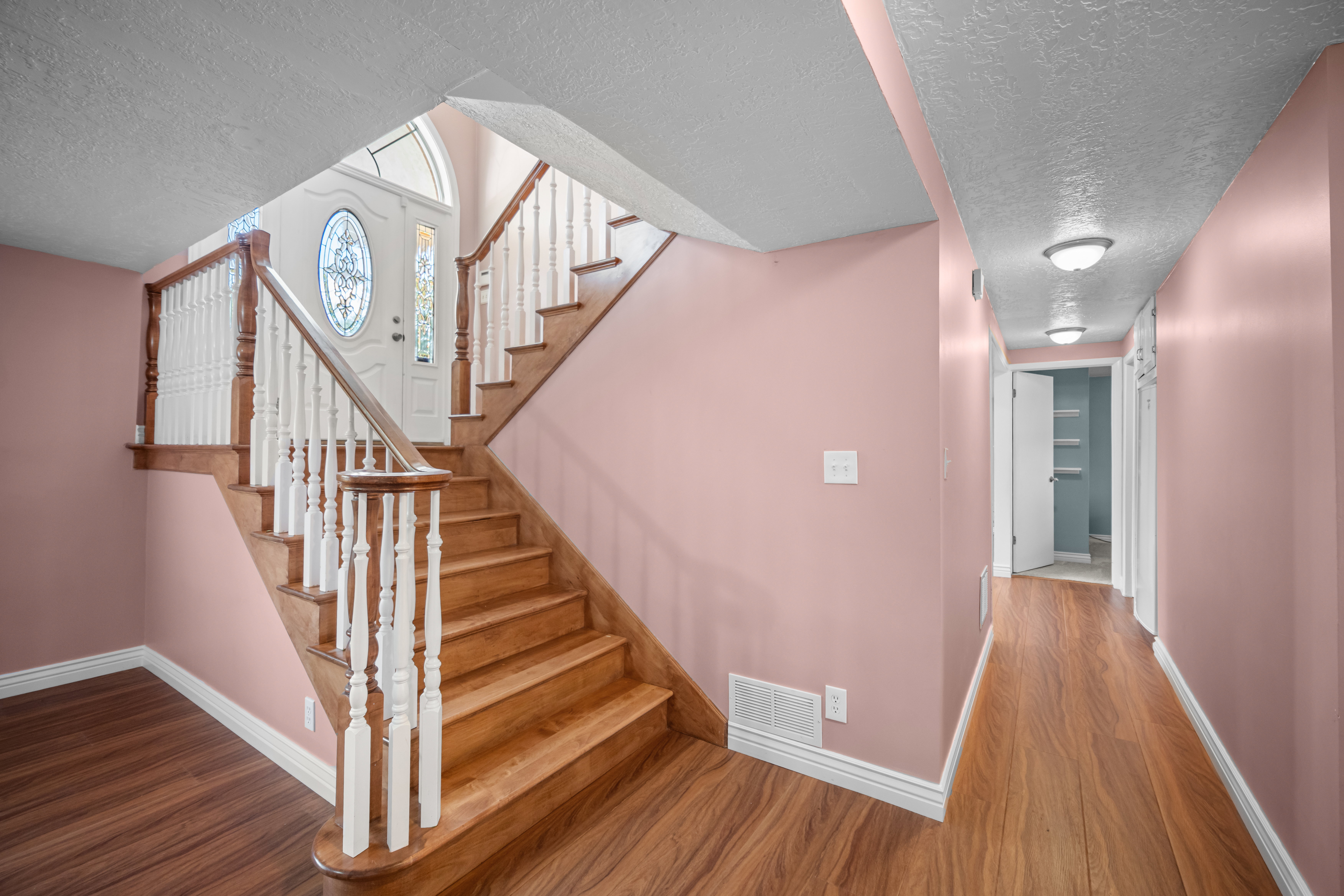 Entryway featuring a decorative frosted glass front door with an arched transom window