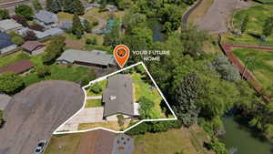 Single-story residence on a cul-de-sac with a paved driveway, featuring mature trees and a substantial green space