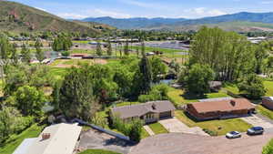 Aerial perspective showcasing the residential area with surrounding green spaces and mountain backdrop