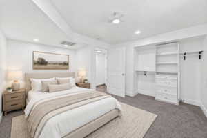 Virtual staging included to showcase room potential. Bedroom featuring recessed lighting, a ceiling fan, plush carpeting, and a built-in closet organization system with shelving and drawers