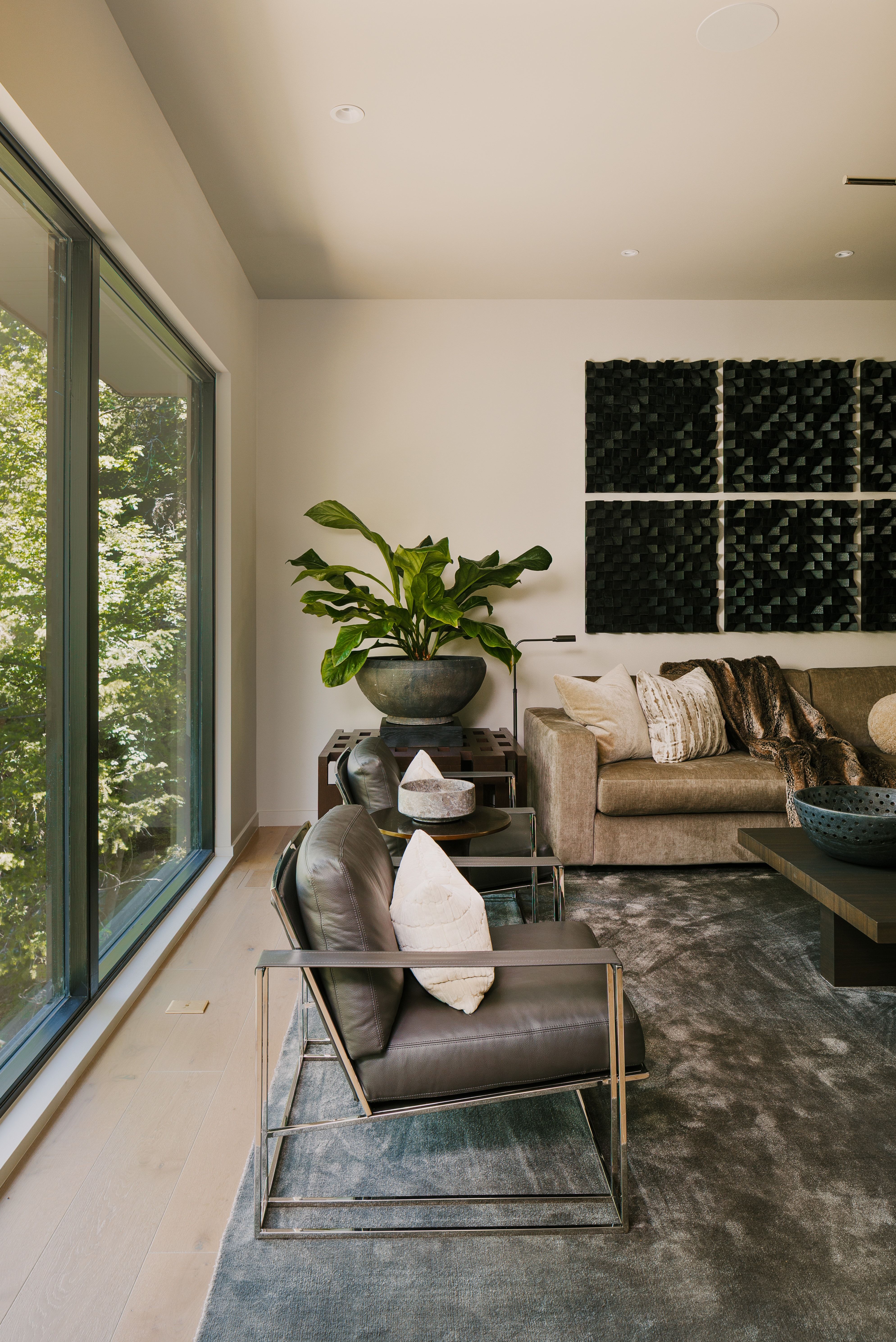 Expansive window wall overlooking lush greenery