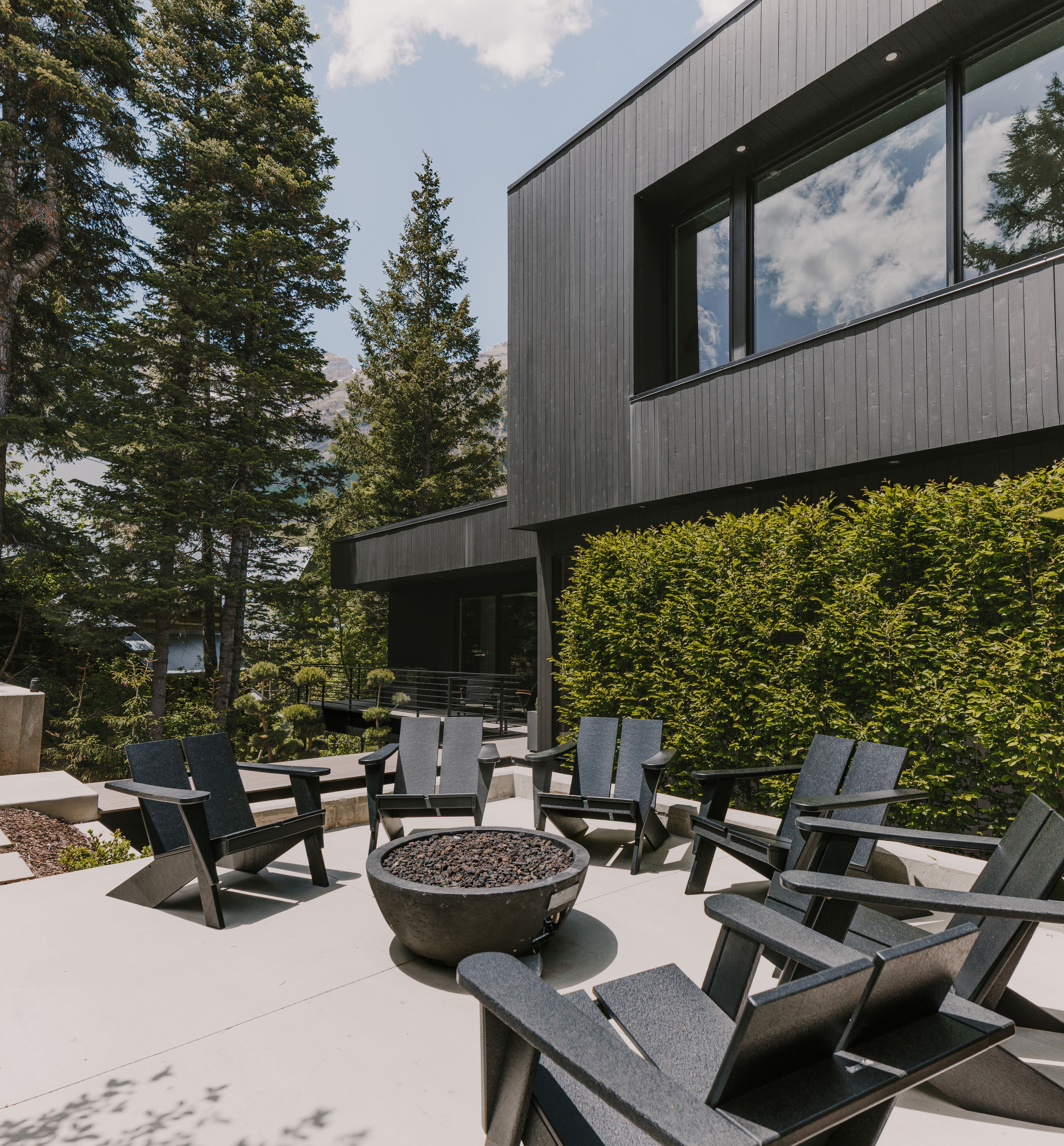 Modern exterior featuring dark vertical siding and large windows