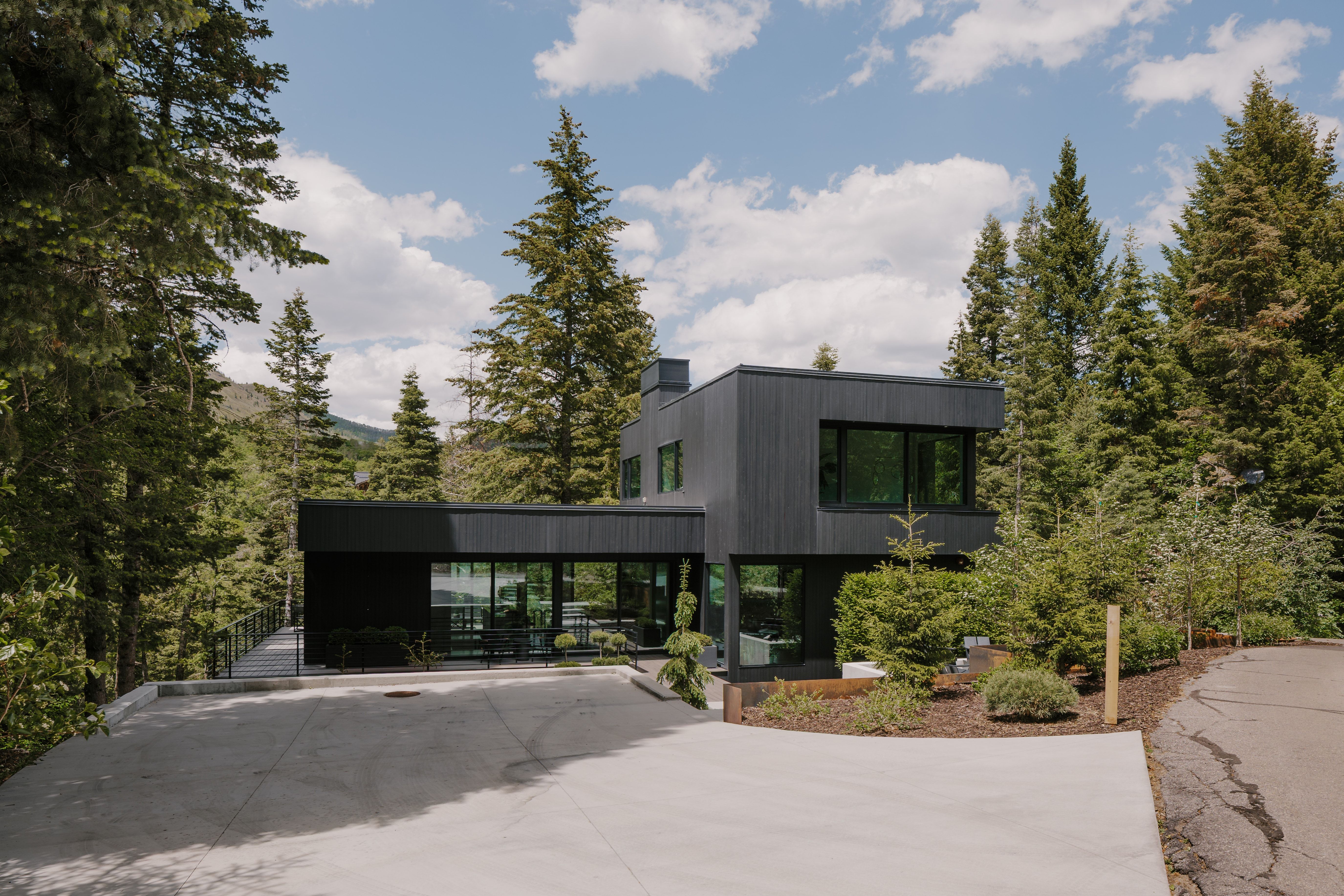 Contemporary exterior architecture with dark-toned siding and multiple large windows