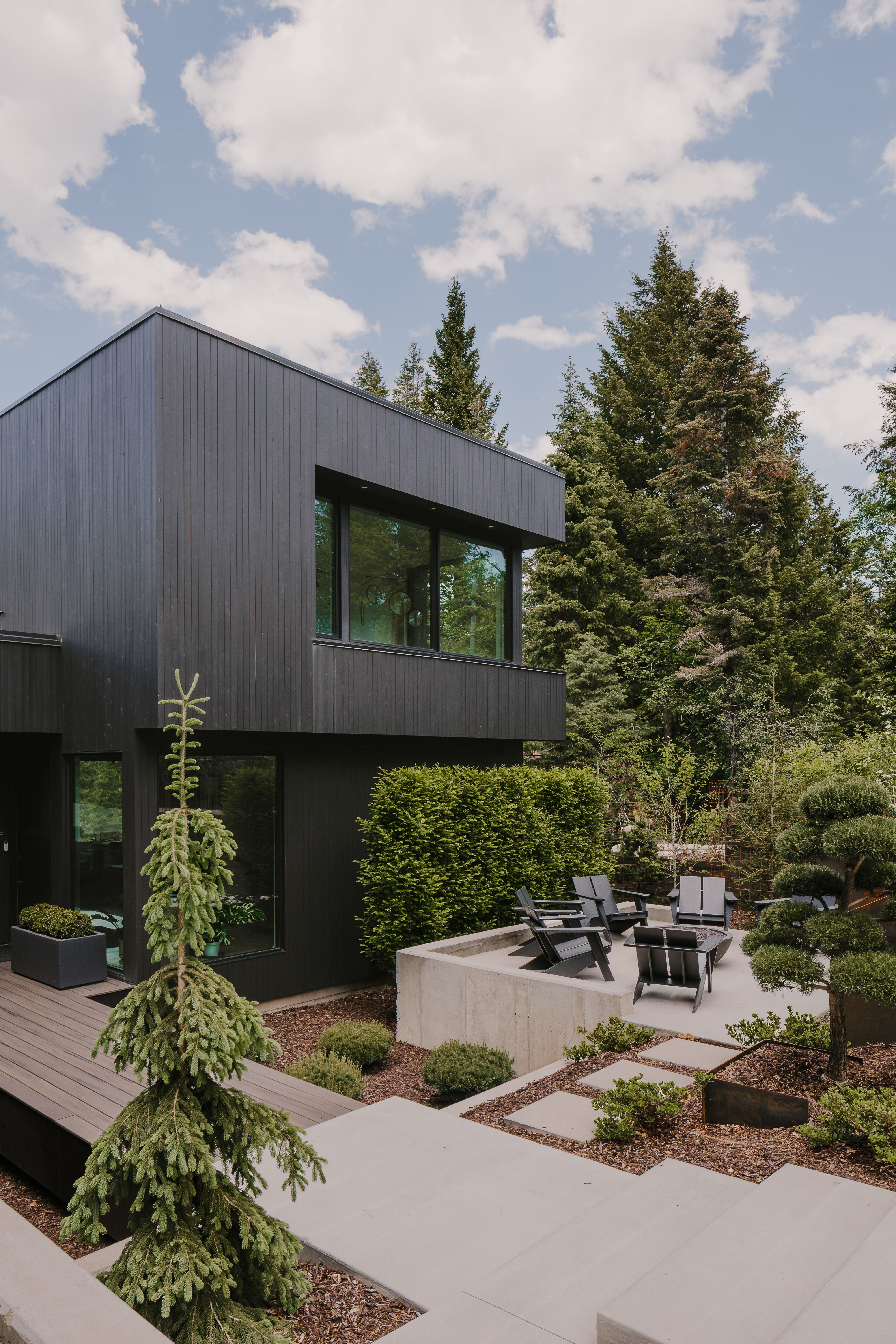 Modern exterior featuring black vertical siding and large windows