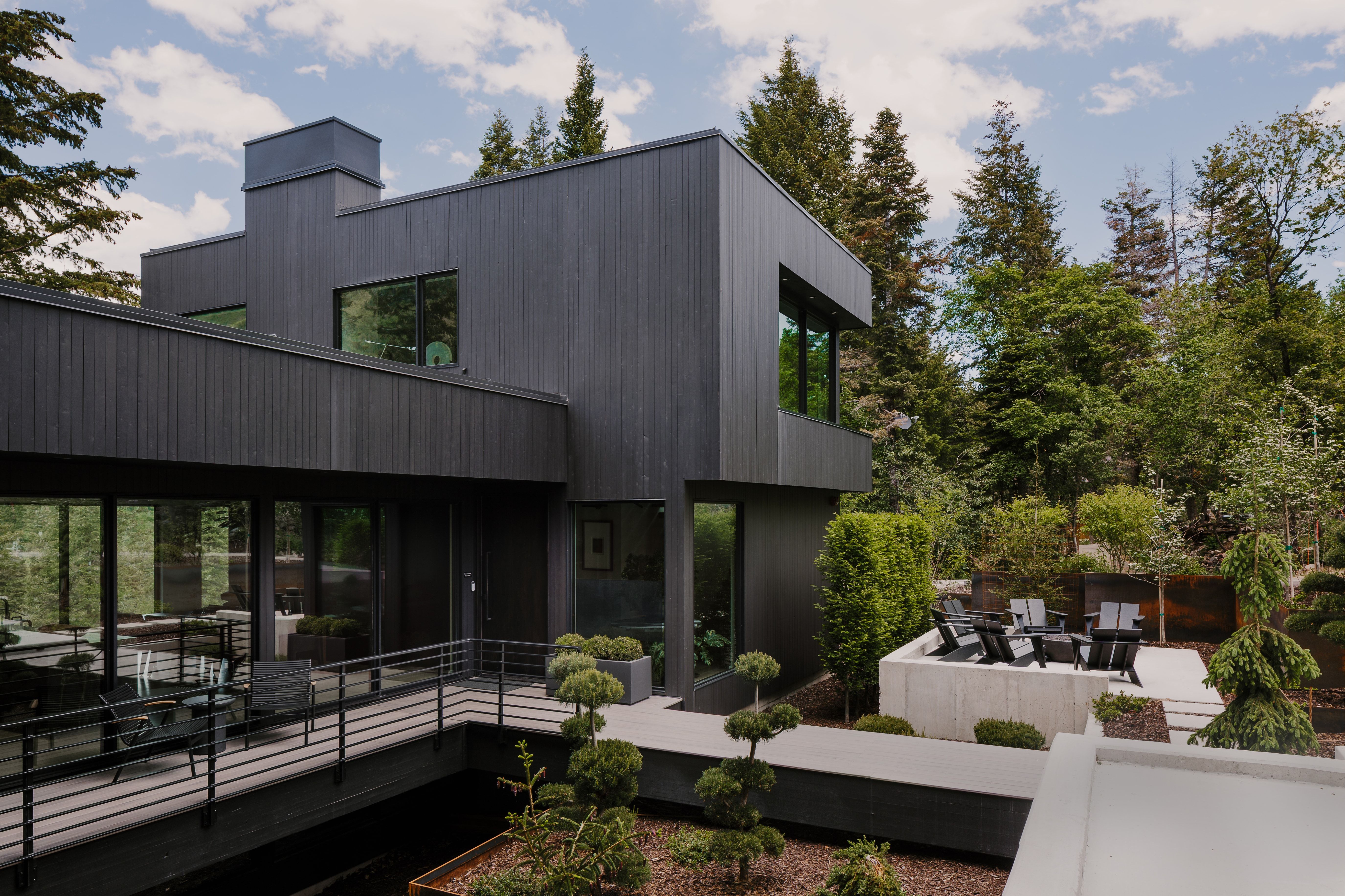 Modern exterior featuring dark vertical siding and a flat roofline