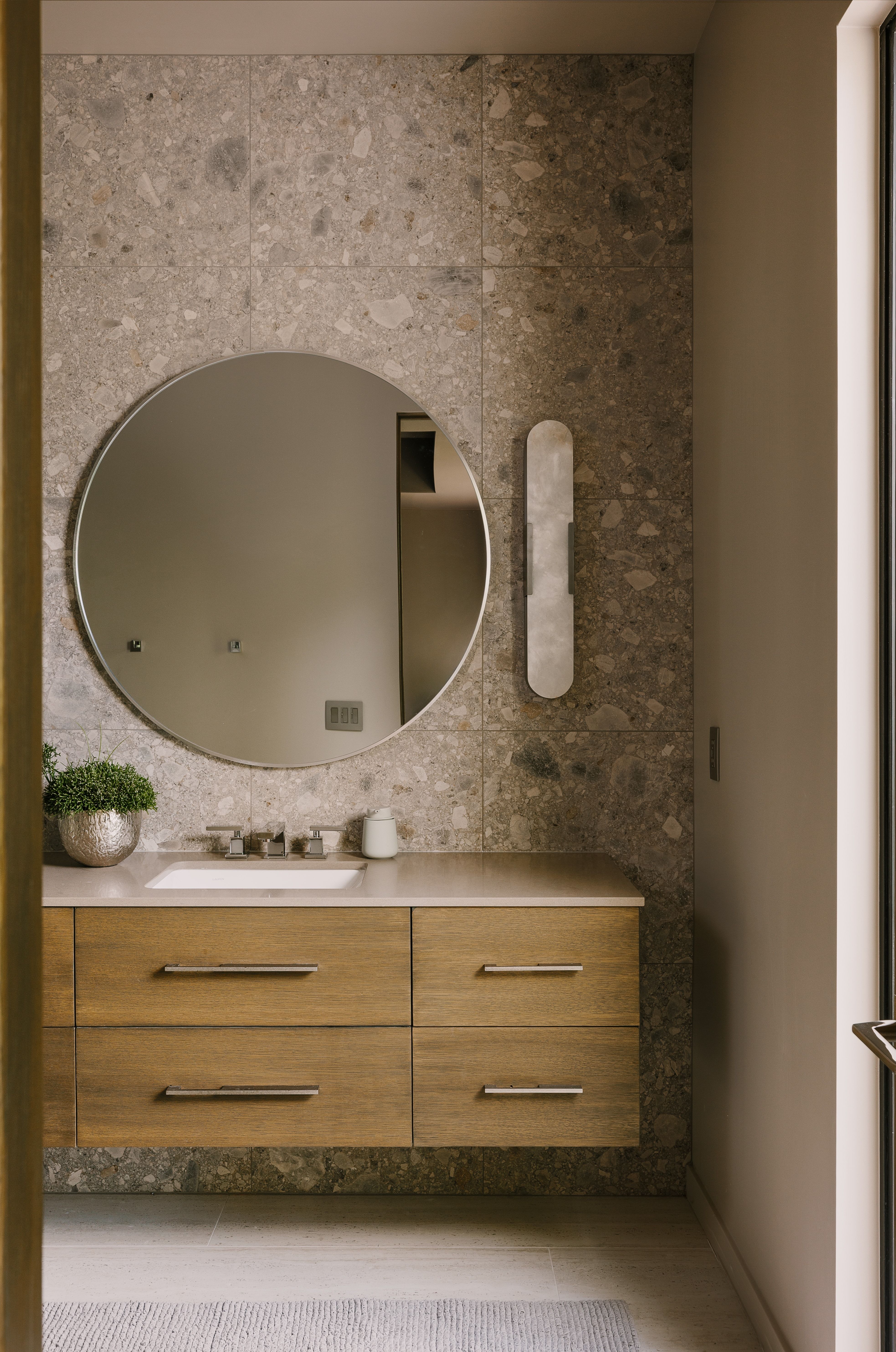 Floating wood-finish vanity with an integrated rectangular sink