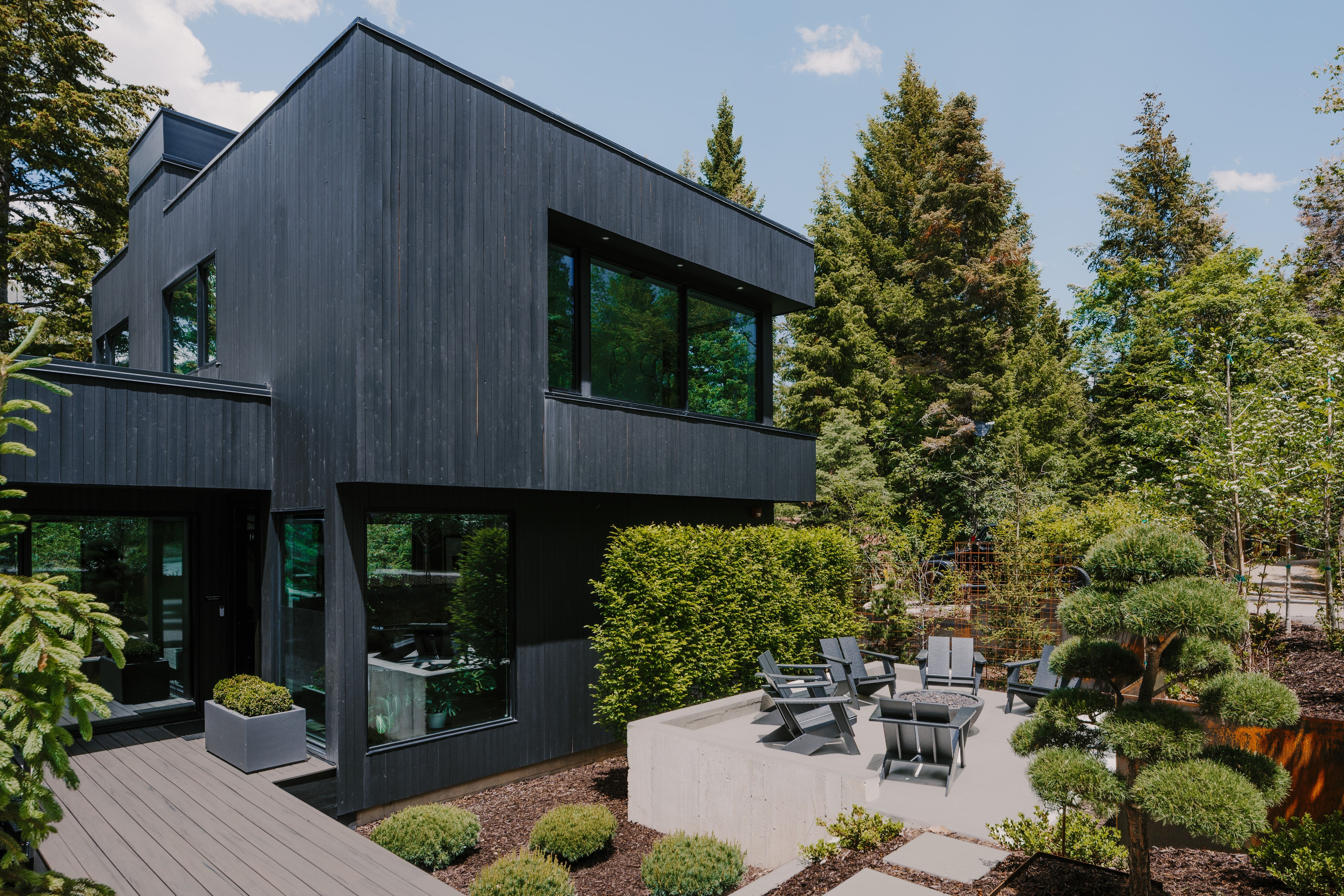 Modern exterior with dark wood-finish siding and expansive windows