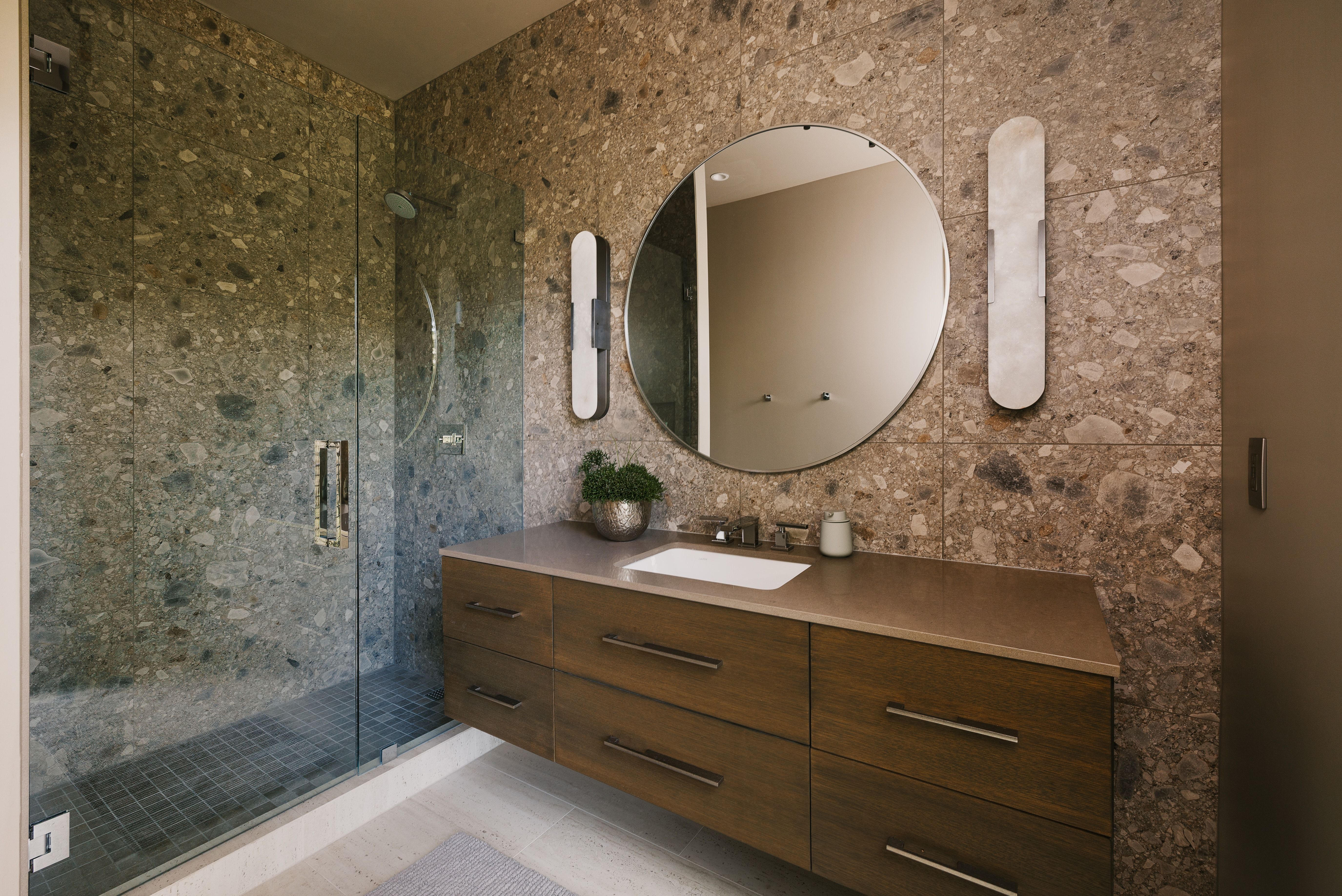 Contemporary bathroom featuring a floating wood-finish vanity with an integrated rectangular sink