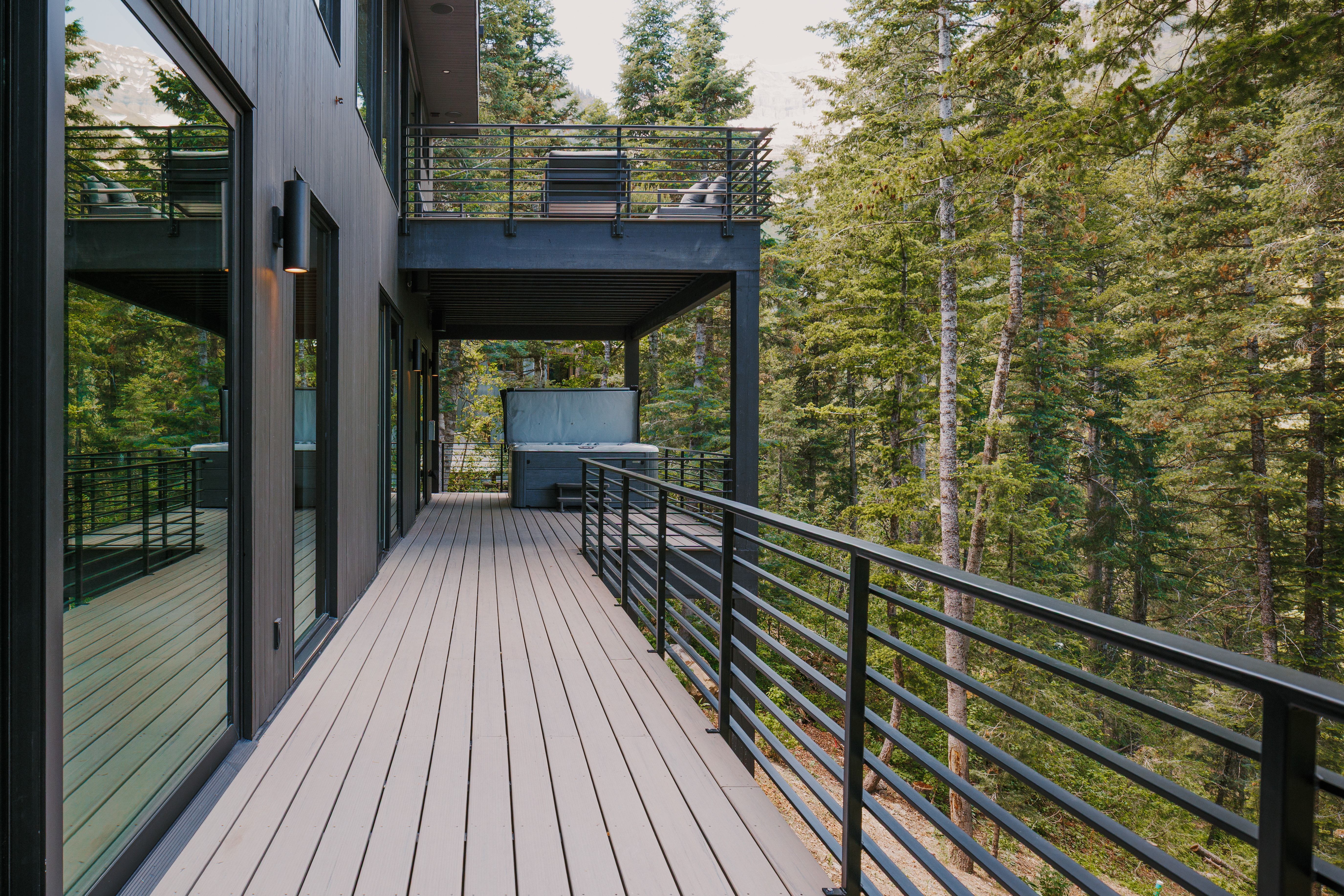 Expansive outdoor deck featuring composite decking and horizontal metal railings