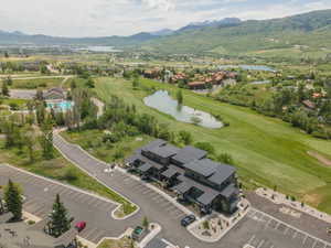 Modern multi-story residential complex featuring dark siding and light trim