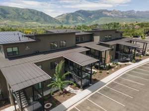 Contemporary multi-level building with dark metal roofing and siding