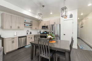 Modern kitchen featuring light wood-finish cabinetry and stainless steel appliances