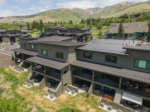Modern townhome complex featuring multi-level units with covered patios and balconies