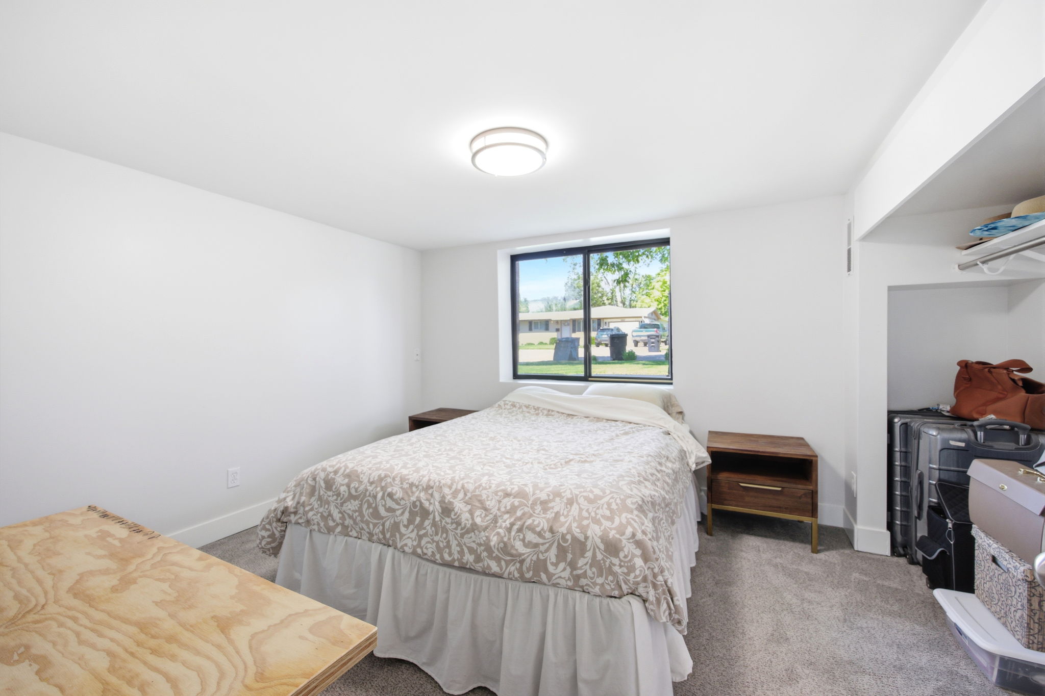 White walls and grey carpet flooring provide a neutral canvas