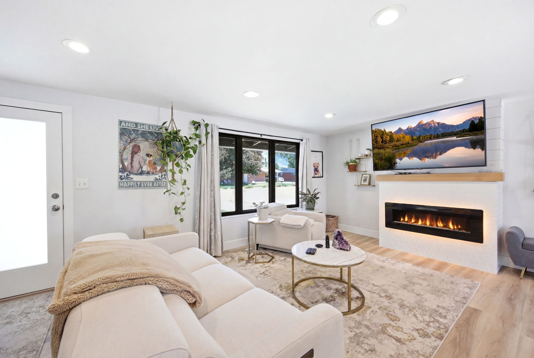 Living space featuring an integrated linear fireplace with a wood mantle, recessed ceiling lights, and wood-finish flooring