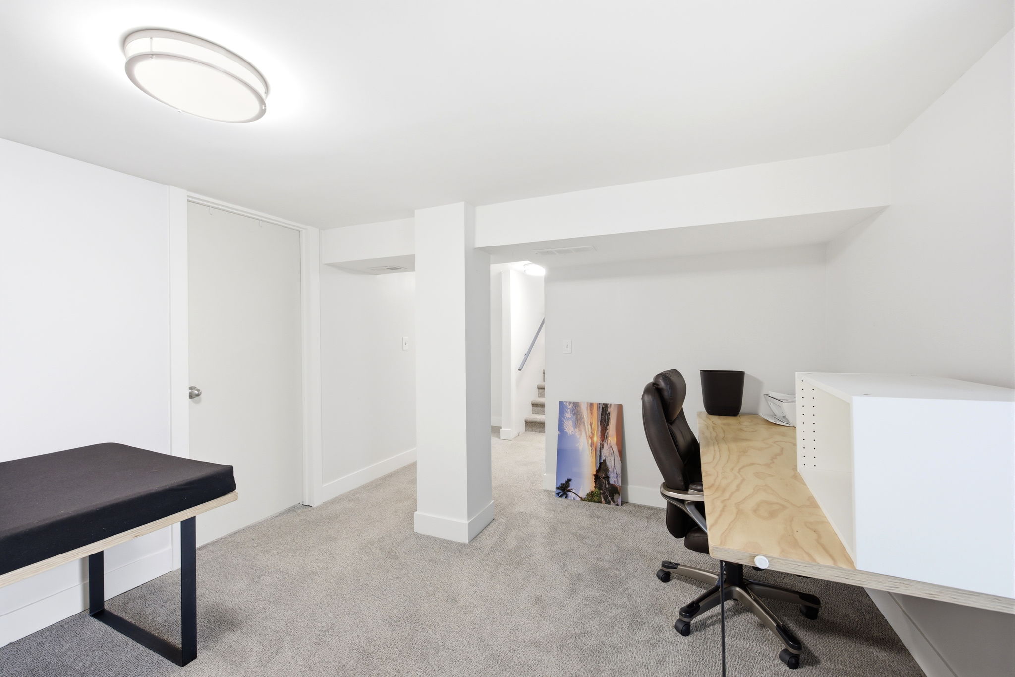 Lower level room featuring light gray carpet, white walls, and recessed lighting
