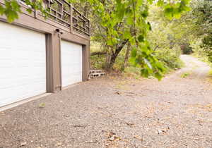 Ground-level two-car garage with white paneled doors and brown trim