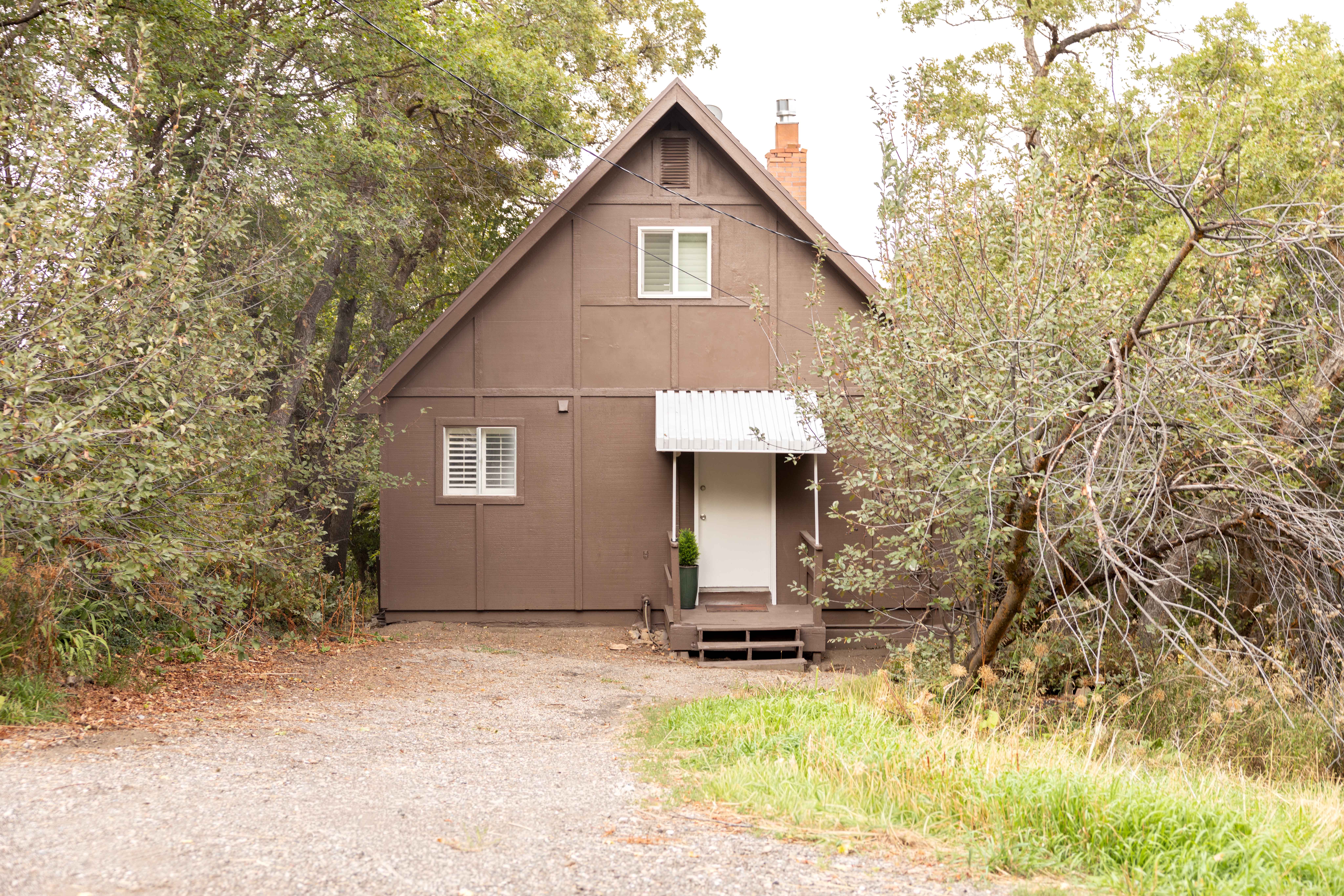 A-frame style residence featuring a brown exterior with white trim