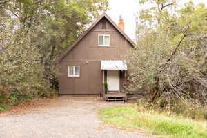 A-frame style residence featuring a brown exterior with white trim