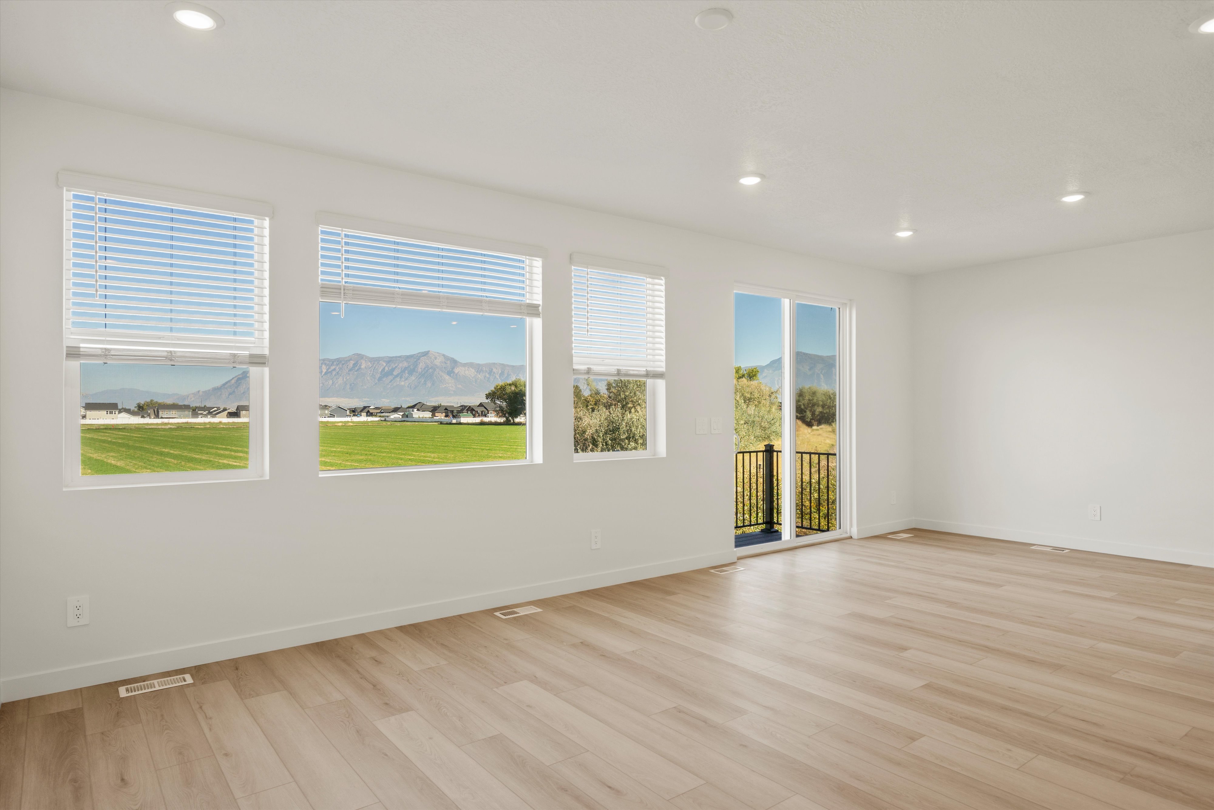 **DISCLAIMER** Interior package may vary. Spacious room featuring wood-finish flooring and recessed lighting
