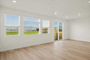 **DISCLAIMER** Interior package may vary. Spacious room featuring wood-finish flooring and recessed lighting