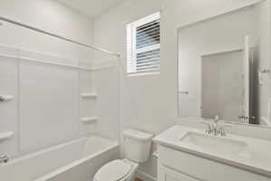 **DISCLAIMER** Interior package may vary. Bathroom featuring a white vanity with an integrated rectangular sink, chrome fixtures, and a large mirror