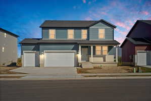 Two-story residence featuring blue horizontal siding and a dark shingle roof