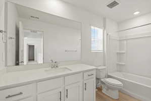 **DISCLAIMER** Interior package may vary. Bathroom featuring a spacious vanity with an integrated sink, polished chrome faucet, white cabinetry, and a large frameless mirror