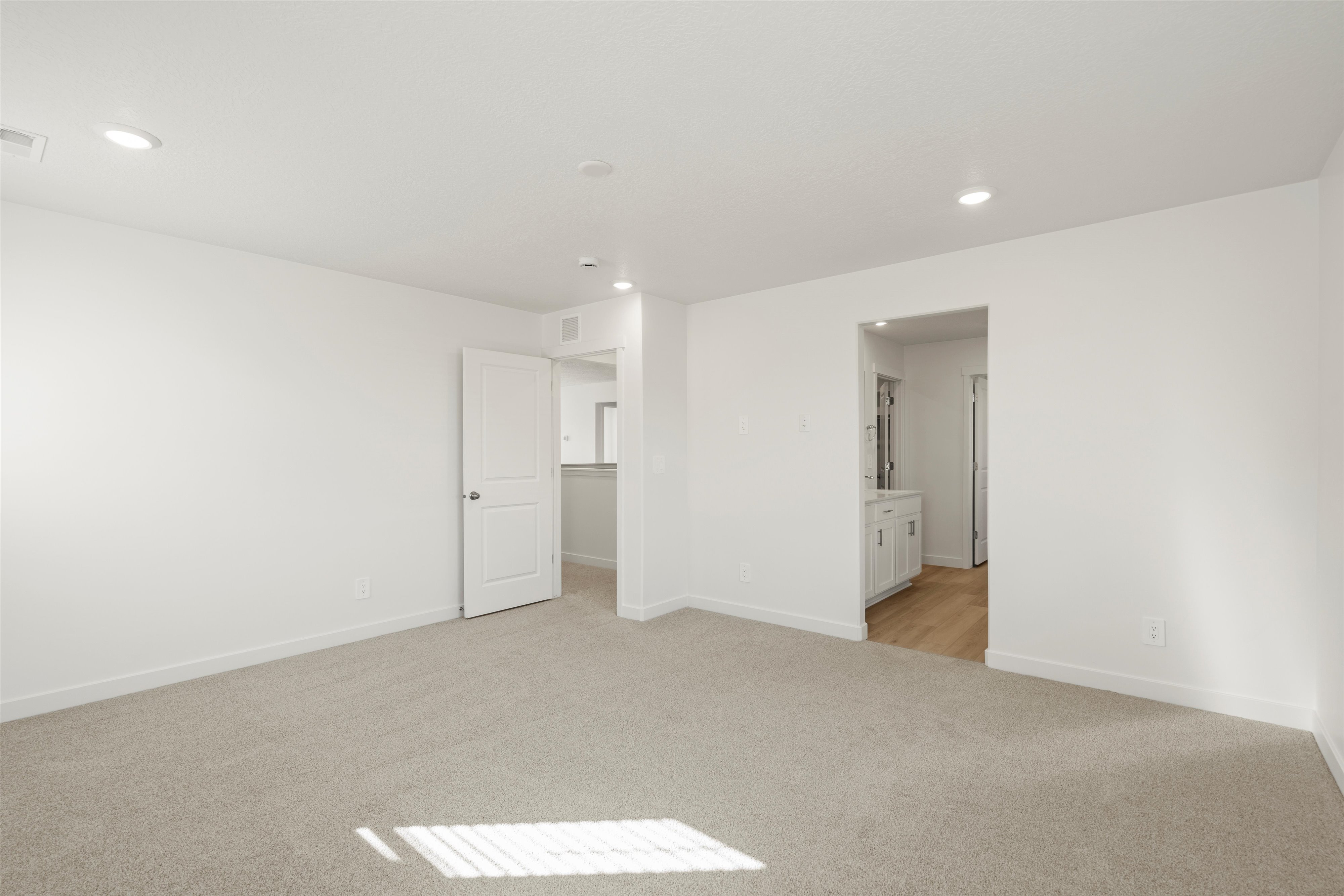 **DISCLAIMER** Interior package may vary. Spacious room featuring neutral carpet flooring and white painted walls