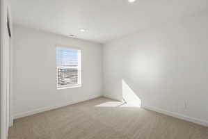 **DISCLAIMER** Interior package may vary. Room featuring neutral-toned carpeting, white walls, and a window with horizontal blinds
