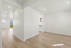 **DISCLAIMER** Interior package may vary. Open concept living area featuring light wood-finish flooring, recessed lighting, and white baseboards