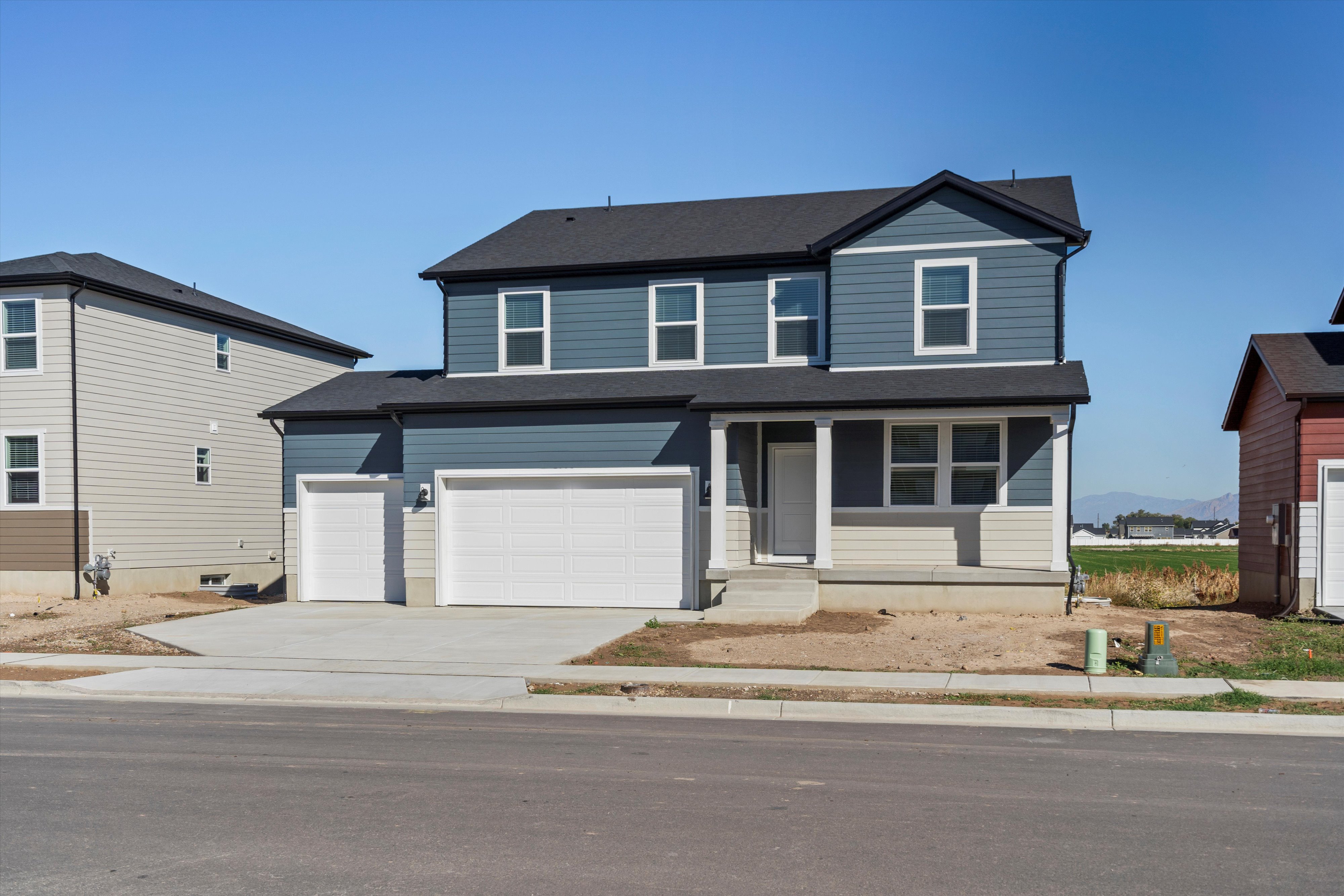 Two-story residence featuring blue and light beige siding with white trim