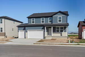 Two-story residence featuring blue and light beige siding with white trim
