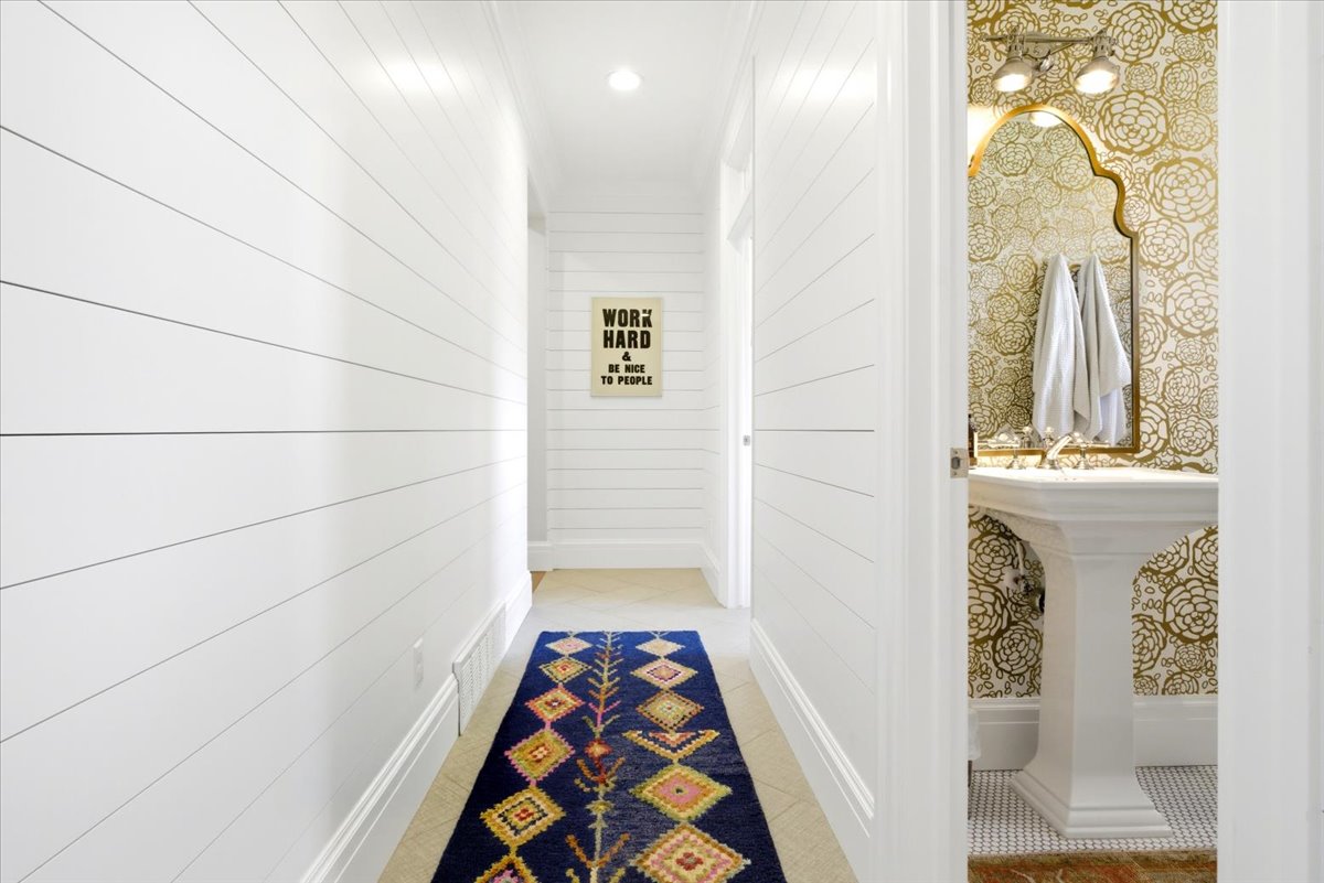 Corridor featuring shiplap walls, recessed lighting