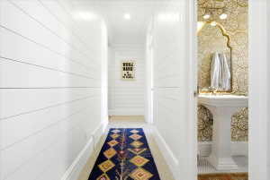 Corridor featuring shiplap walls, recessed lighting
