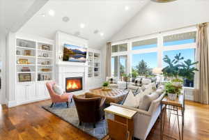 Vaulted ceiling living space featuring large windows