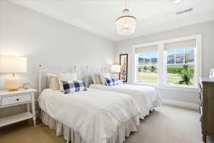 Bright bedroom featuring two large windows with amazing views