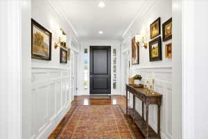Entryway featuring wainscoting and crown molding