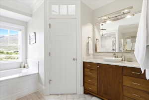 Master Bathroom featuring a wood-finish double vanity with a marble countertop and a vessel sink