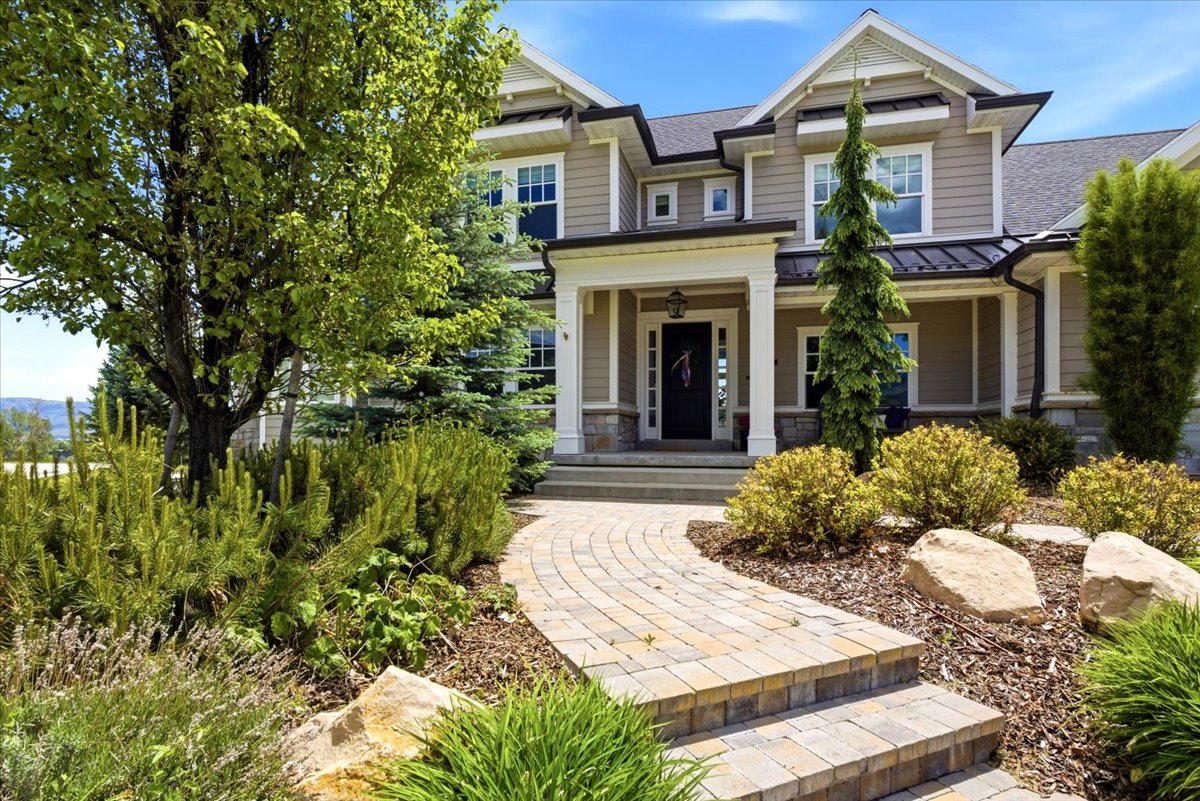 Front of Home walkway featuring shrubs