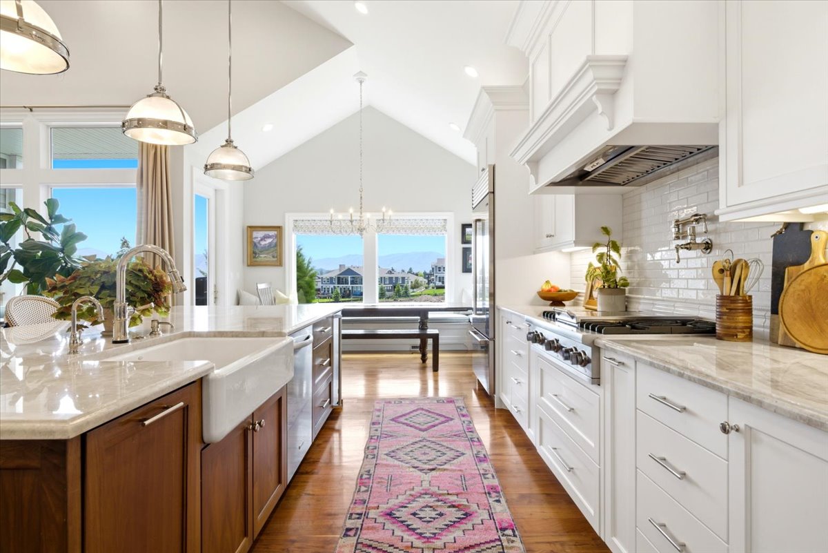 Bright kitchen featuring a vaulted ceiling and hardwood flooring