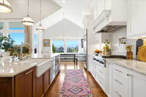 Bright kitchen featuring a vaulted ceiling and hardwood flooring
