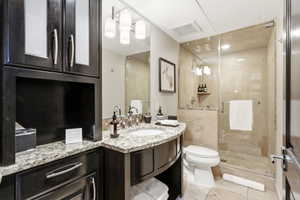 Curved vanity with a granite countertop and undermount sink