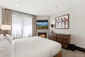 Corner fireplace with mantel, featuring an integrated television above
