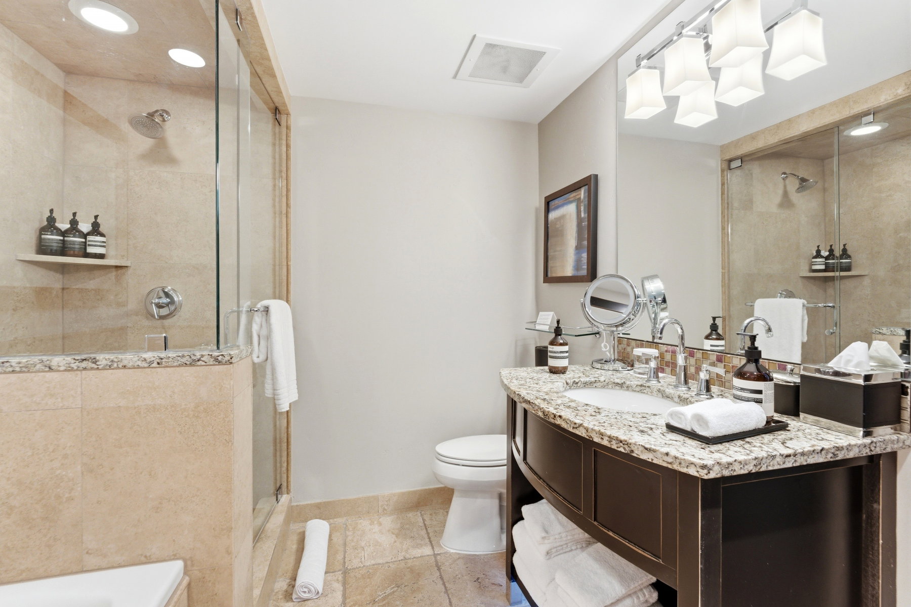 Bathroom featuring a glass-enclosed shower with recessed lighting and a built-in shelf